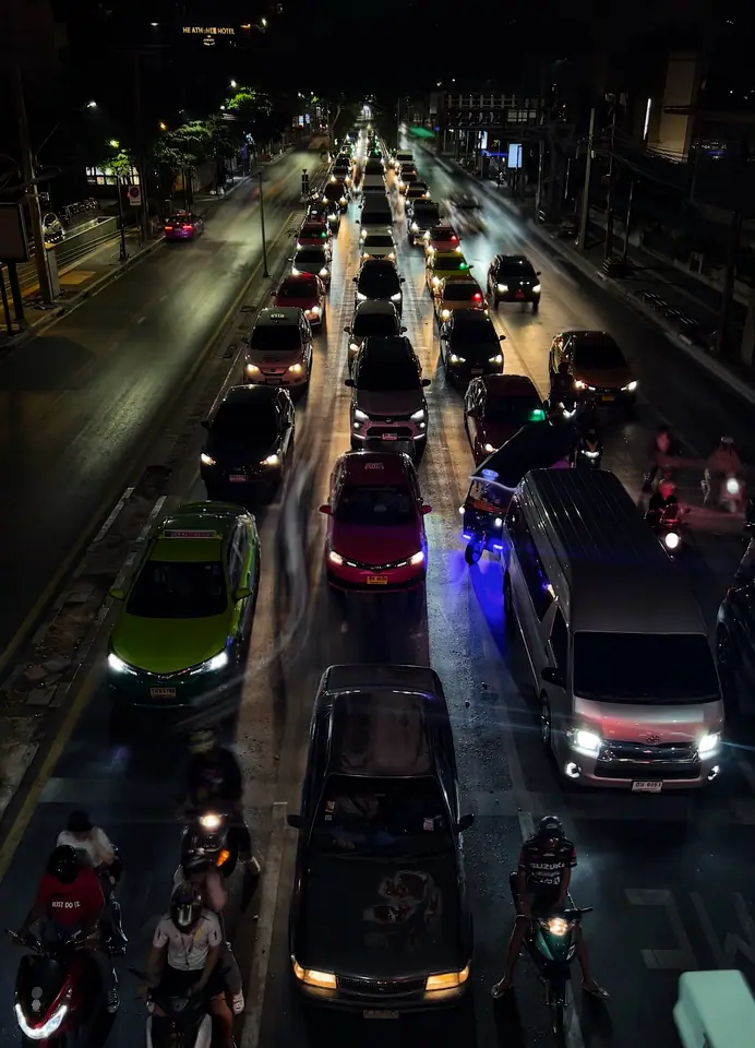 Dense Bangkok traffic scene at night viewed from above.