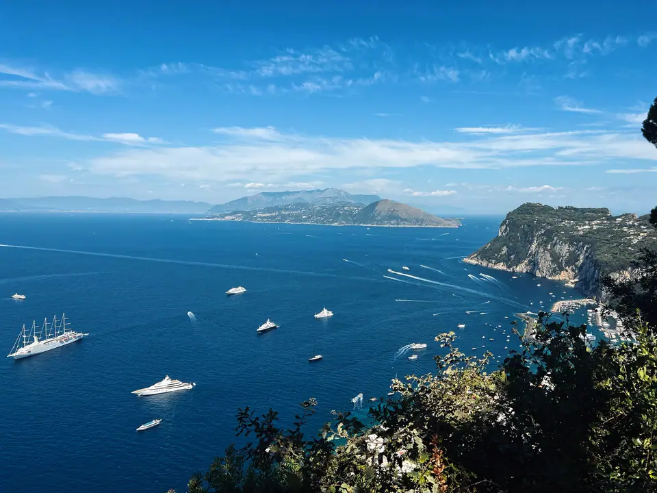 Coastal Capri view with boats tracing motion across the sea.