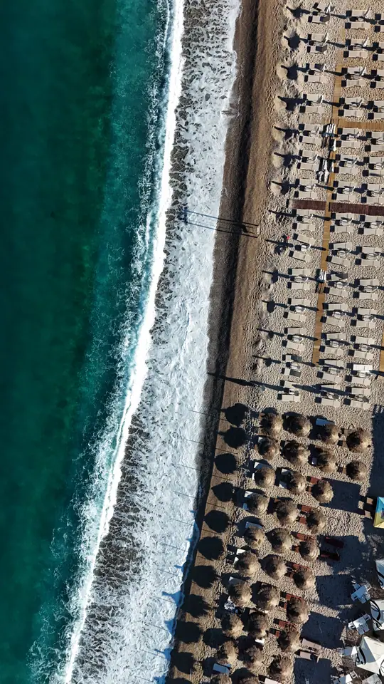 Drone study of shore break, umbrellas, and repeating beach structure.