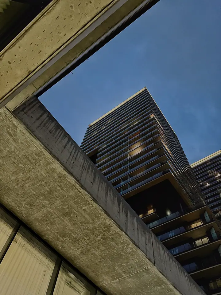 Low-angle study of modern Vienna facade geometry against blue dusk.